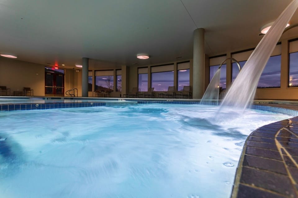 Gentle waterfalls and crystal-clear waters create a peaceful indoor oasis.