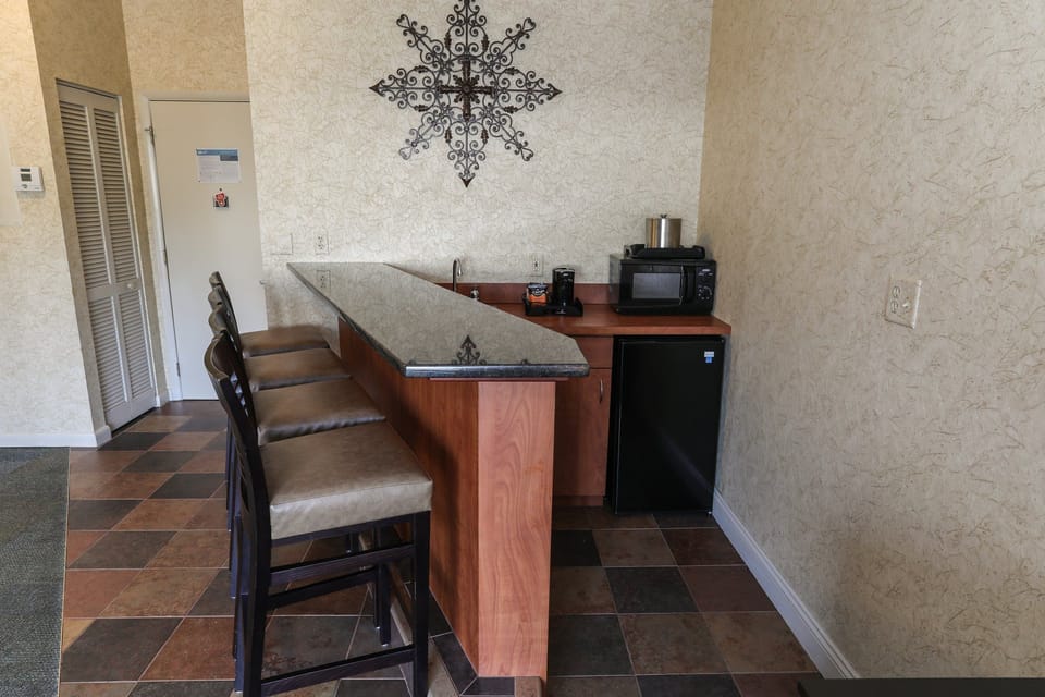 Compact kitchenette with a breakfast bar, perfect for preparing snacks and light meals.