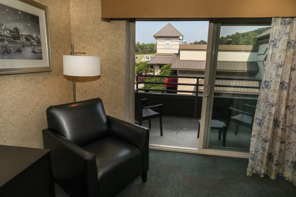 Cozy seating area with a chair and lamp, offering a relaxing space next to the balcony.