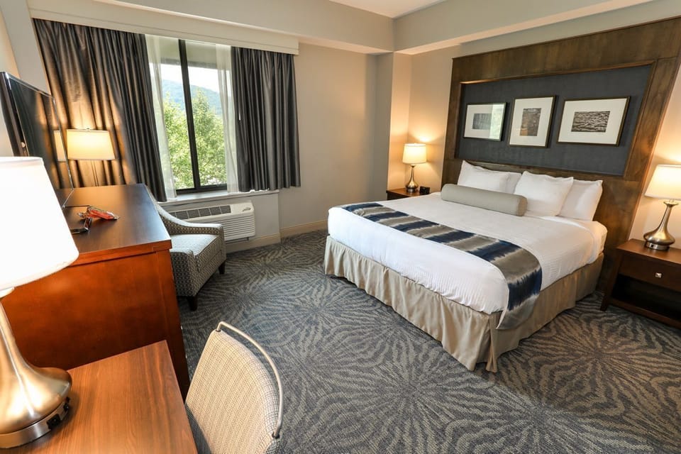 Elegant and inviting guest room with plush bedding and warm décor.