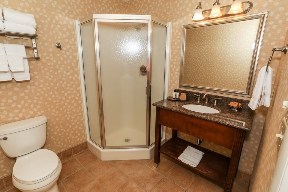 Elegant bathroom with a walk-in shower and classic vanity, providing modern amenities.