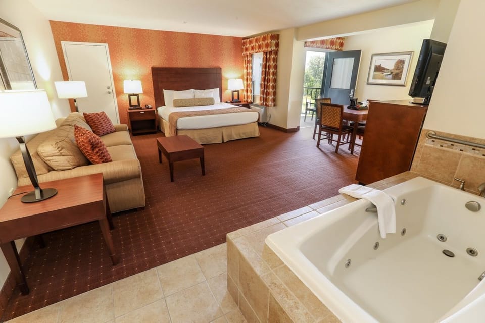 Spacious suite featuring a cozy seating area and an in-room whirlpool tub for ultimate relaxation.