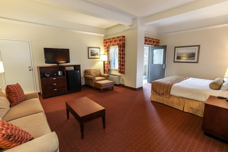 Comfortable living area with a sofa, TV, and ample space for relaxing or entertaining.