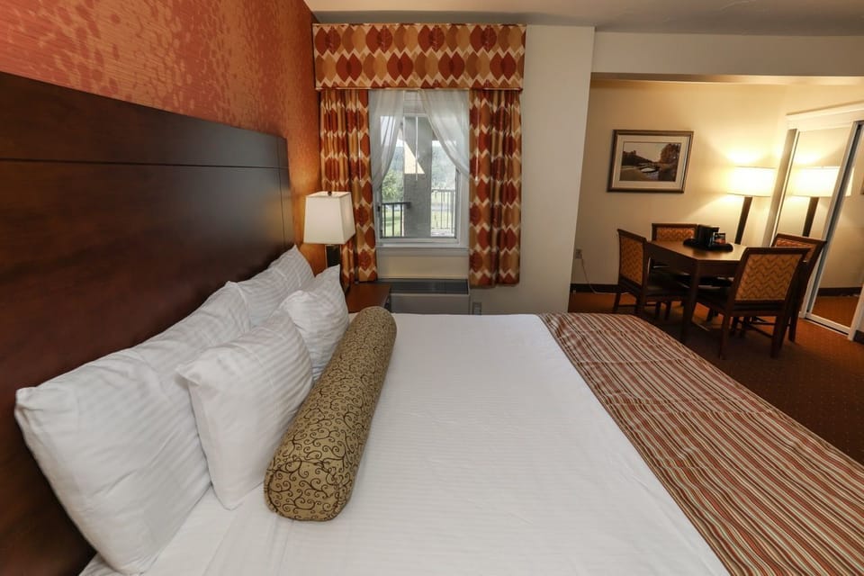 Comfortable guest room with a plush bed and access to a private balcony with scenic views.