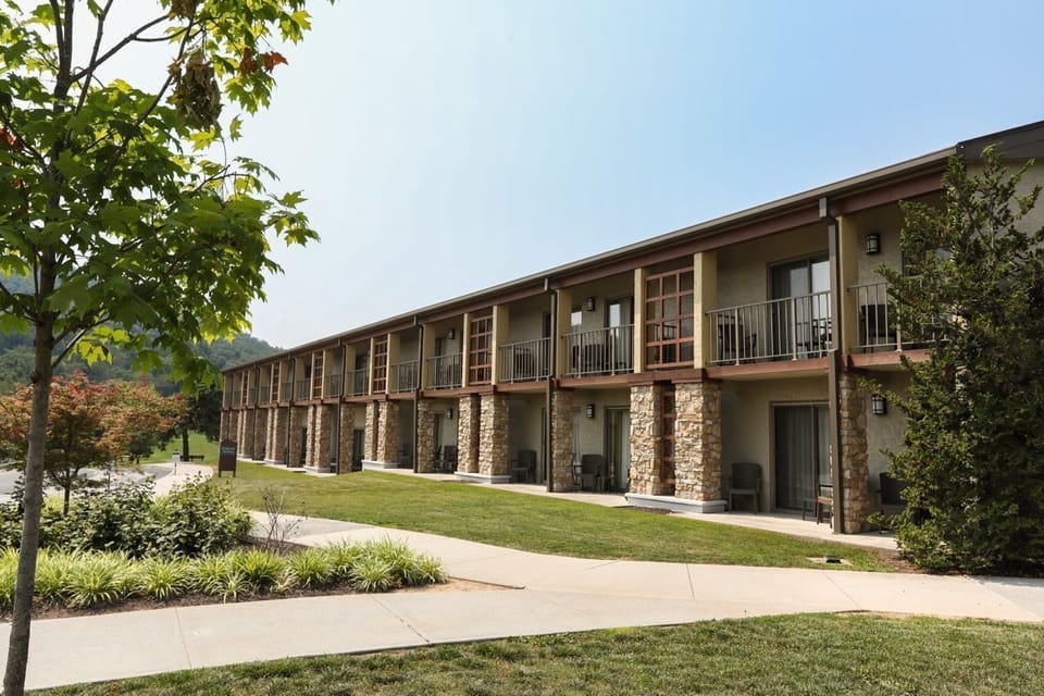 Rustic charm and lush landscaping create a welcoming retreat surrounded by nature.