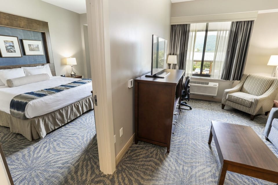 Spacious guest room with a comfortable bed and a cozy seating area for relaxation.
