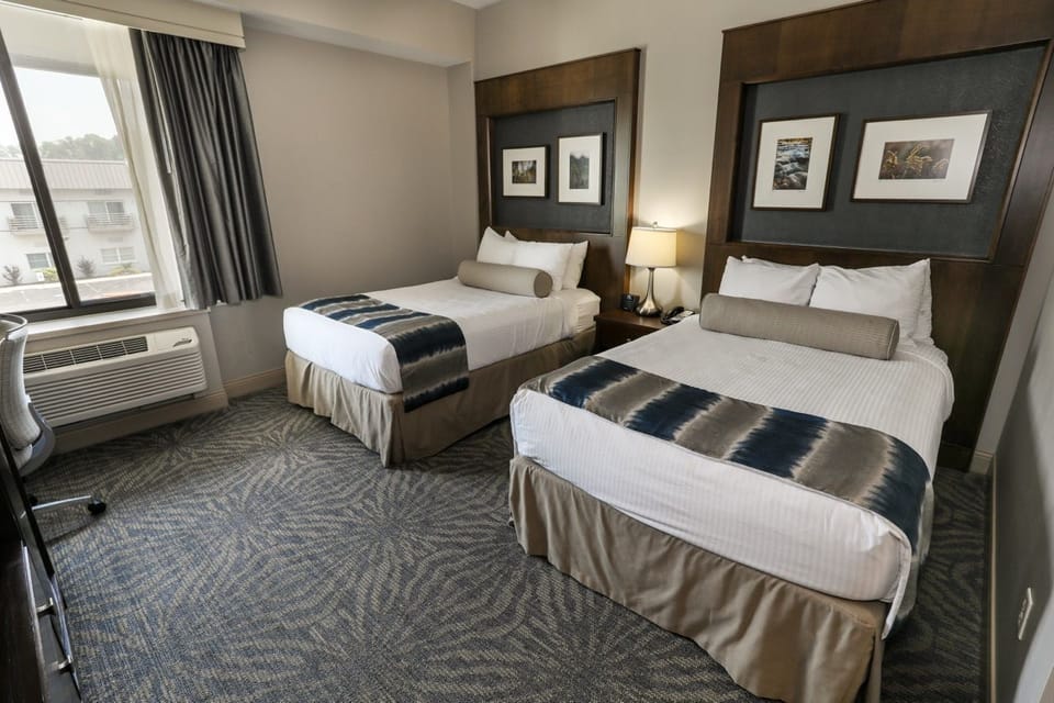Bright and airy room with two plush beds and plenty of natural light.