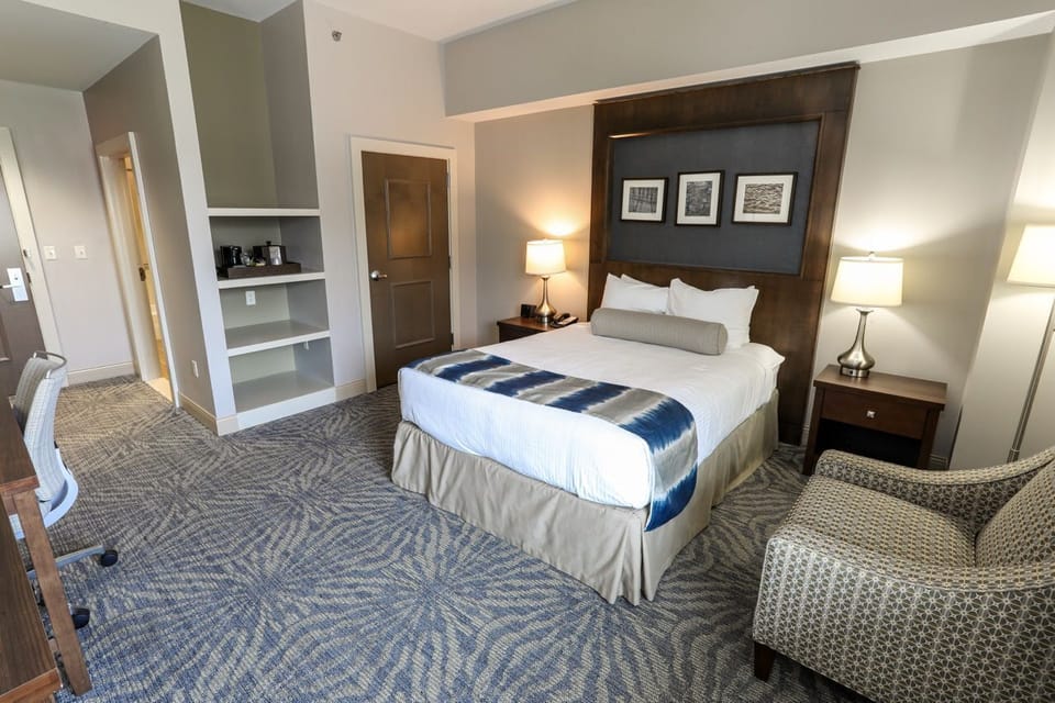 Spacious guest room with a plush bed and seating area, perfect for relaxation.