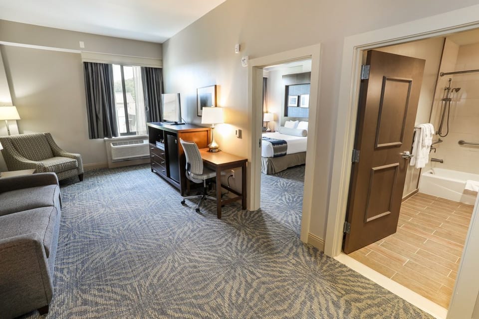 Well-appointed suite offering a work desk and ample seating, ideal for both work and leisure.
