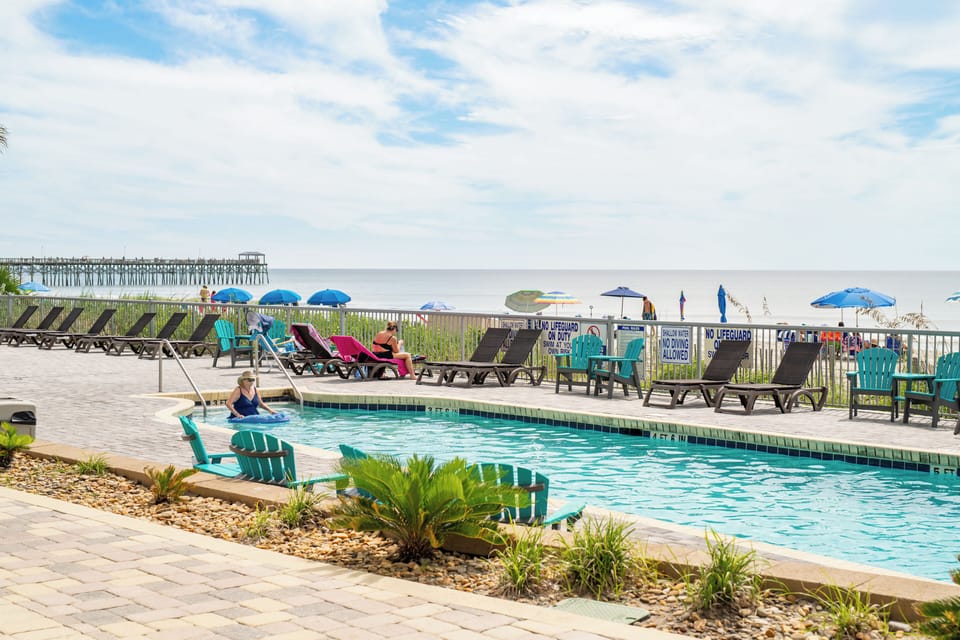 Pristine beachfront with lounge chairs and umbrellas
