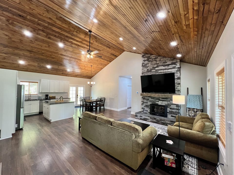 Spacious living room with vaulted wood ceilings and open layout.