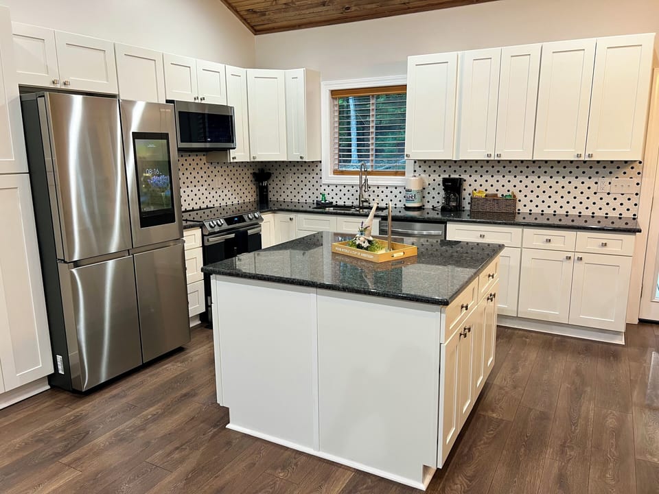 Fully stocked kitchen with modern appliances and large island.