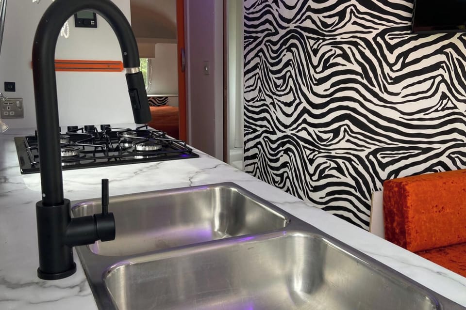 Kitchen Area with Cooker, fridge, drinks fridge and seating area