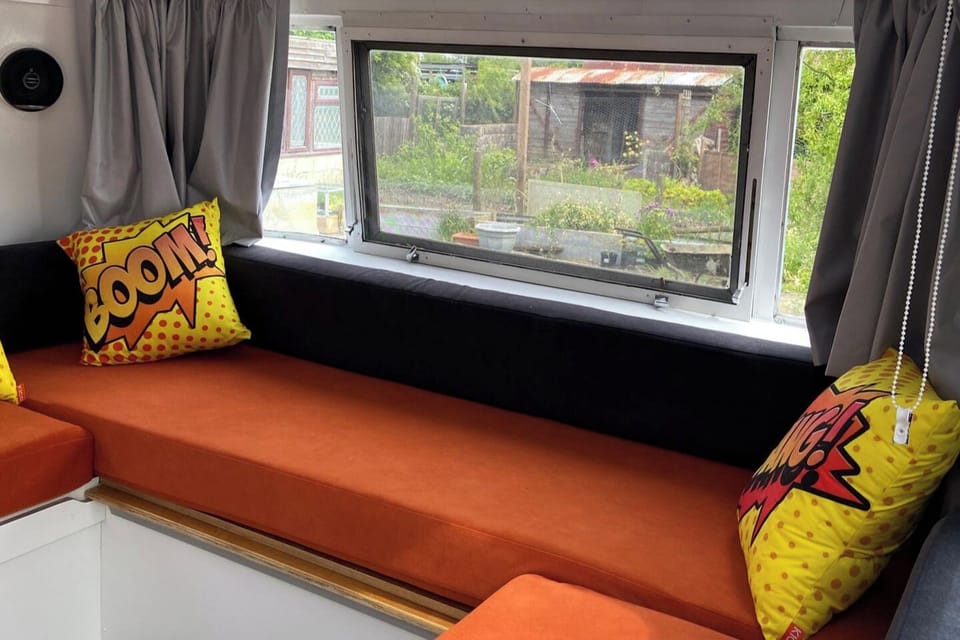 Seating area which pulls out to accommodate  a double sleeping area