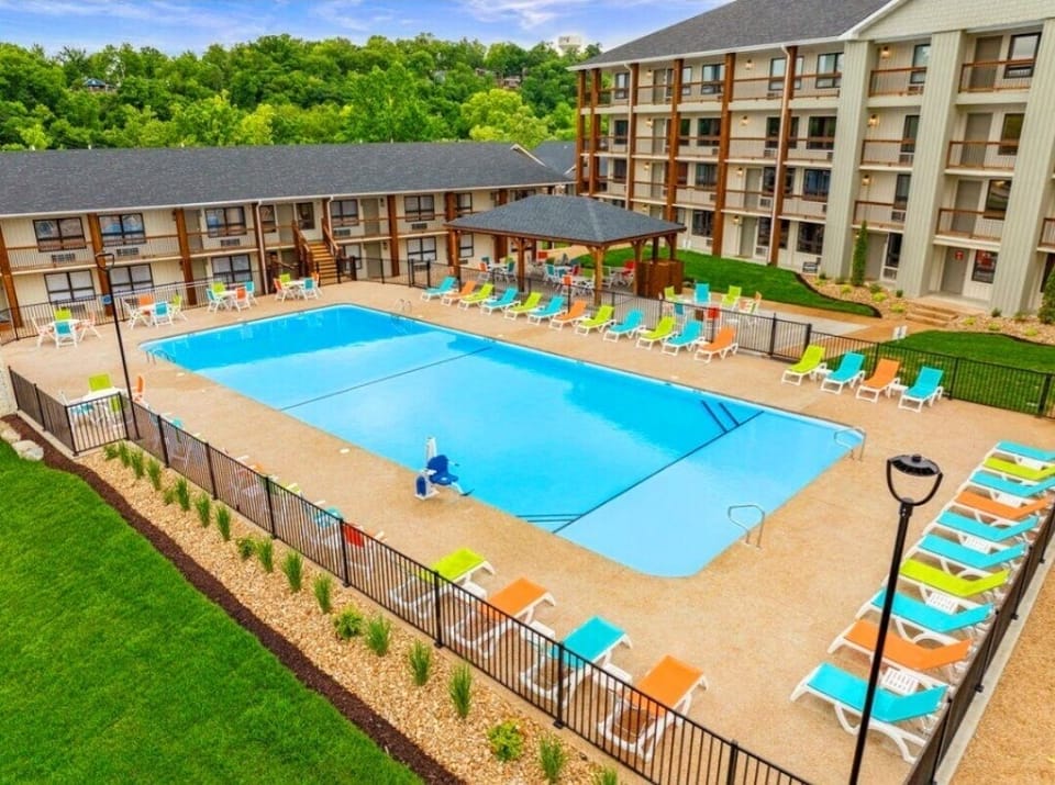 Olympic-sized swimming pool with a handicapped-accessible chair. 