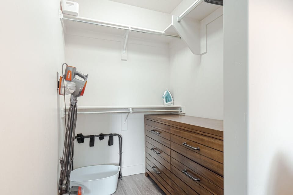 Walk-in wardrobe with dresser, vacuum and iron
