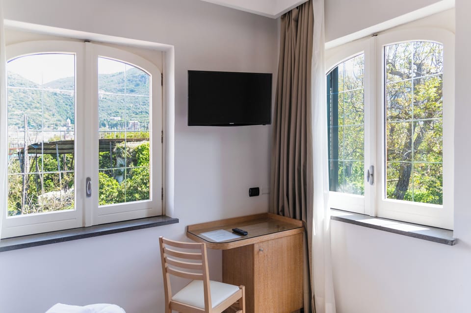 Comfort Triple Room, Garden View | In-room safe, blackout drapes, soundproofing, iron/ironing board