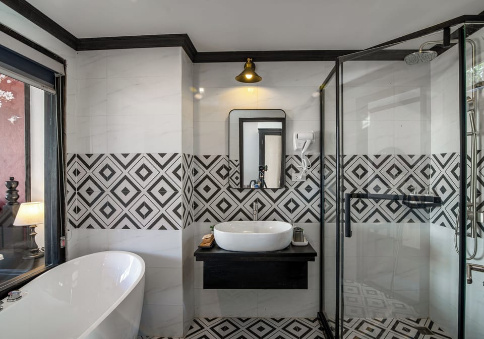 Twin pool view with bathtub | Bathroom | Shower, free toiletries, hair dryer, slippers