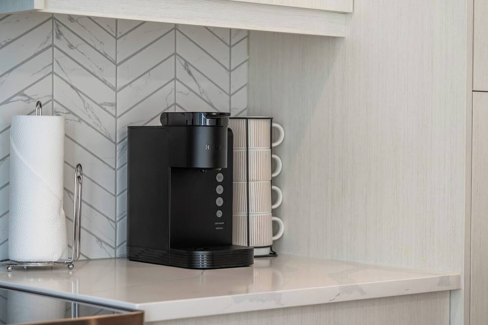 Multiple Coffee Options Available: This home features several coffee options, including a Keurig, a pour-over setup (bring your favourite ground coffee), and a Nespresso Zenius machine. Note that the Nespresso pods can only be purchased via Your Key
