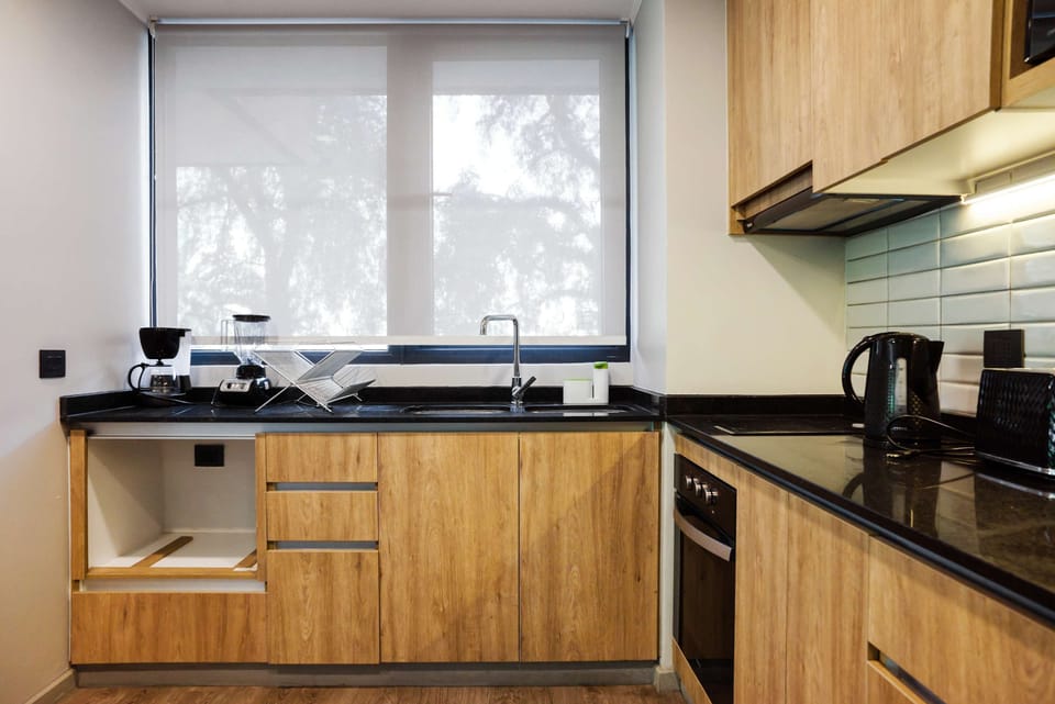 Bright and modern kitchen with sleek appliances and ample natural light, ideal for culinary enthusiasts.