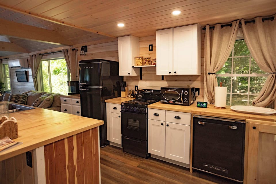 Open kitchen with island seating, flowing directly into the living area.