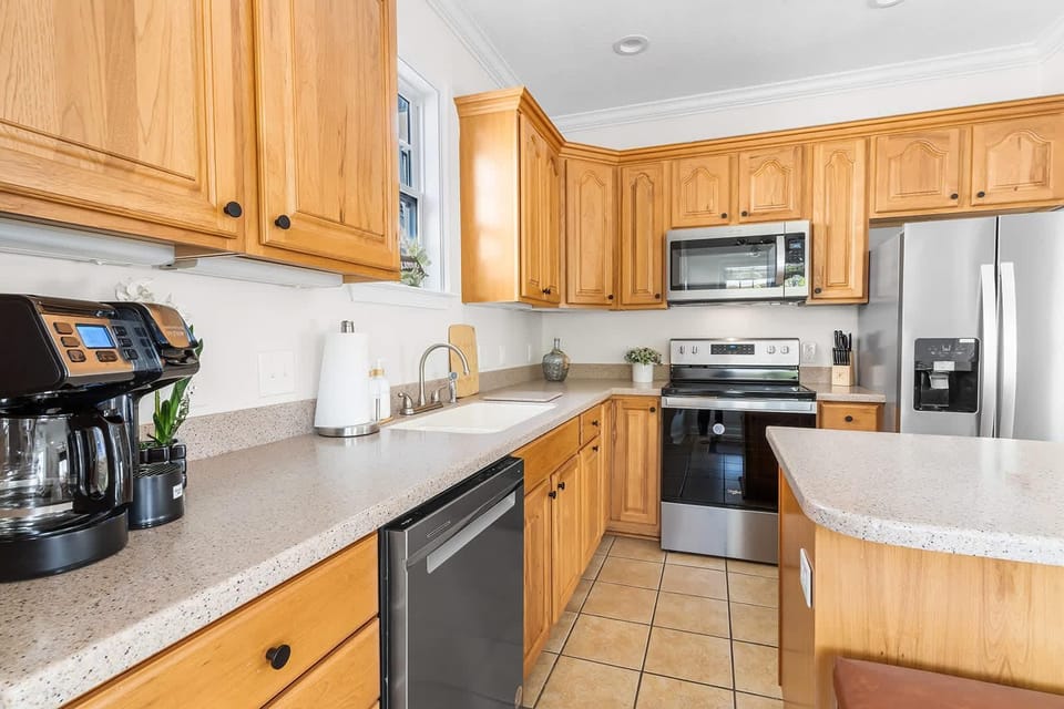 Spacious kitchen with modern appliances and warm wood cabinetry