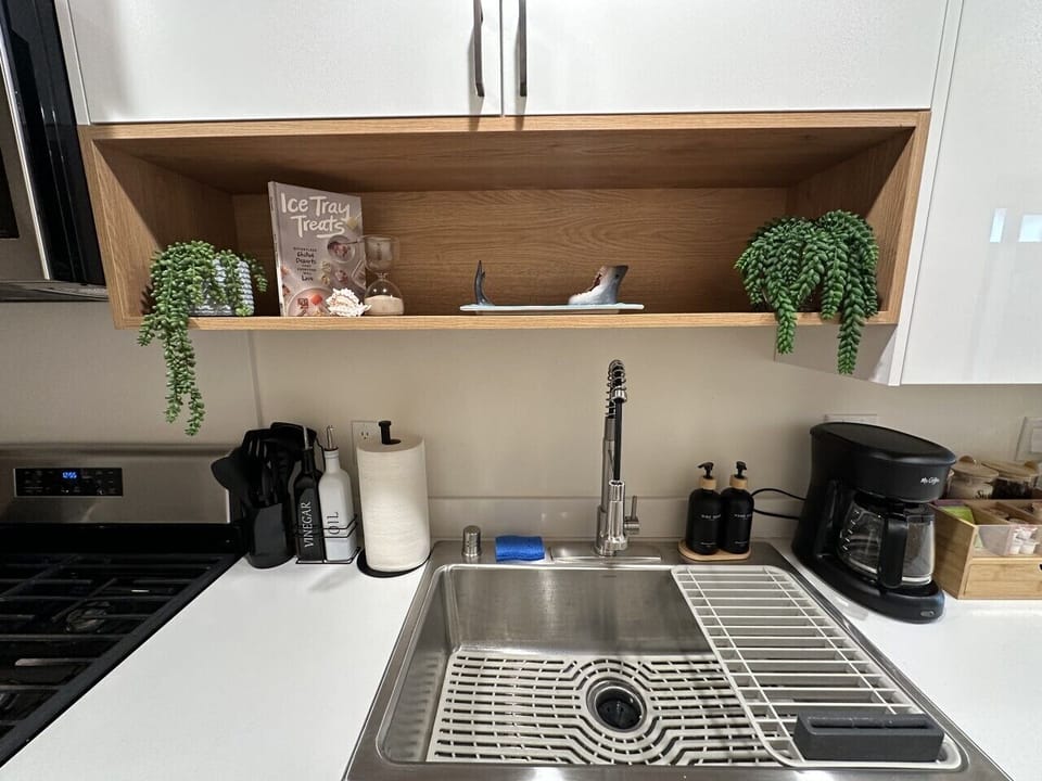 Clean and modern kitchen sink area with sleek fixtures, ample counter space, and everyday essentials. Thoughtfully designed for convenience, making meal prep and cleanup easy and efficient.
