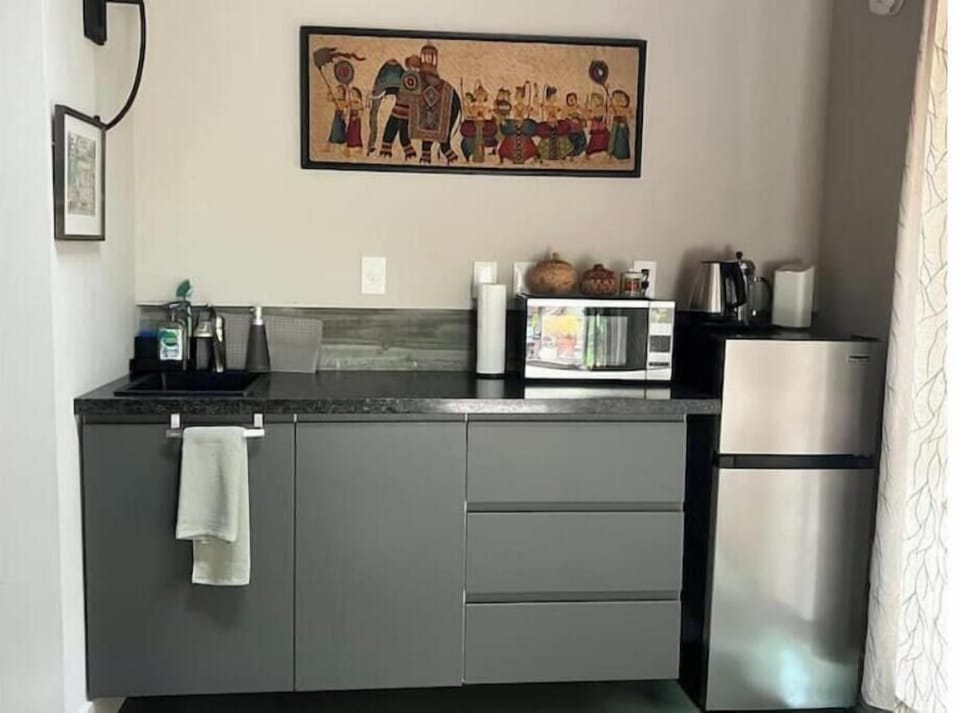  coffee, teas, hot water pot 
 induction stove, sink
dishes, pots, utensiil