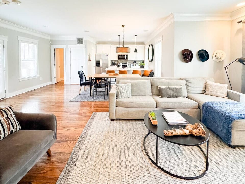 Spacious open floor plan with a bright kitchen, dining area, and comfy living room—plus a sofa that converts into a queen sleeper for extra guests. Perfect for groups to gather and relax!