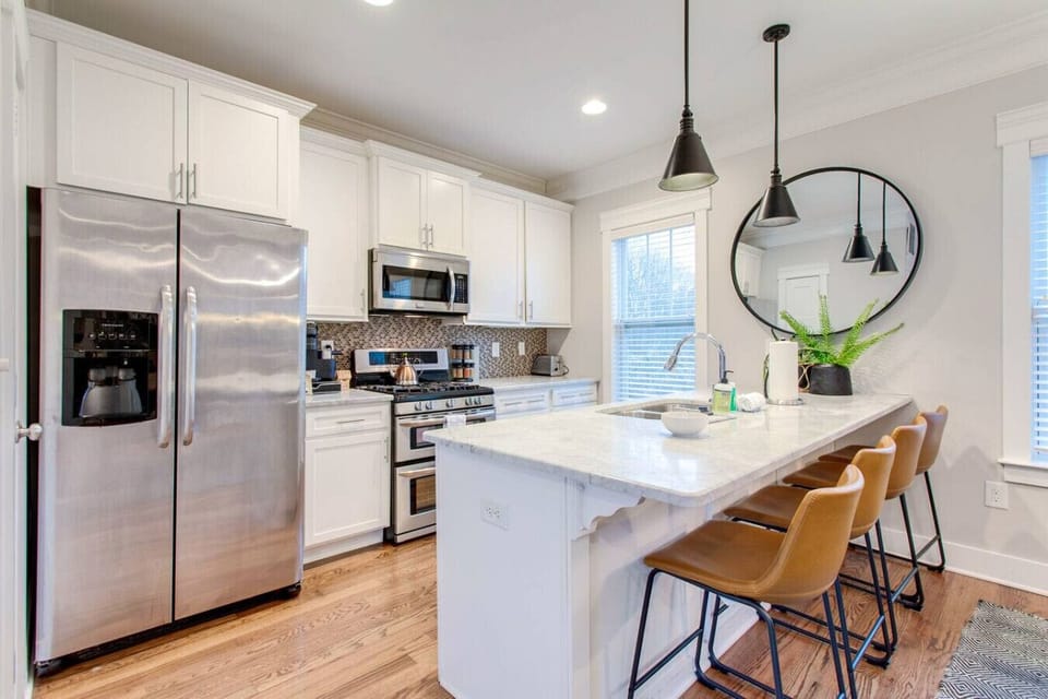 Bright, modern kitchen with stainless appliances, spacious counters, and bar seating—perfect for quick breakfasts, coffee runs, and pre-Broadway snacks.