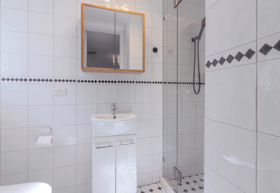Ensuite bathroom off master bedroom with hand held shower accessory