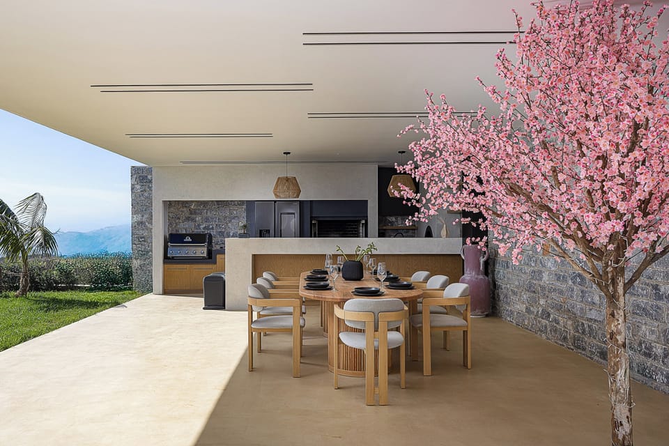 Οutdoor dining  area for 8 guests under a shaded pergola