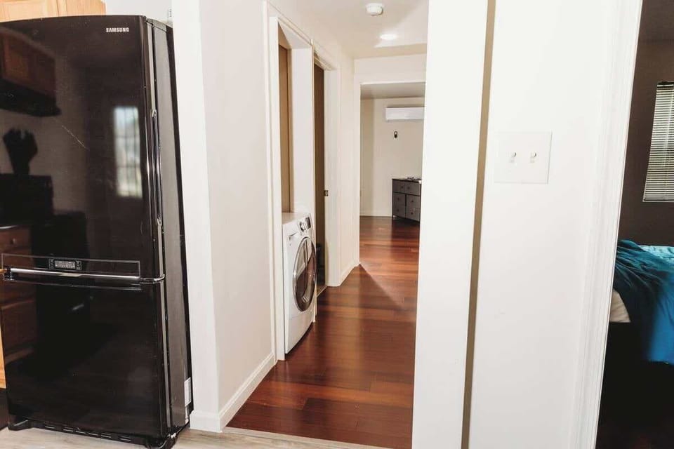 Hallway leading to laundry and rooms.