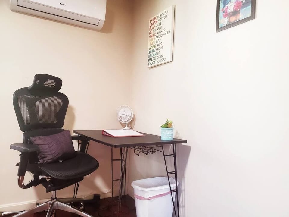 A comfortable and functional workspace featuring a sleek desk, ergonomic chair, and a calming decor, perfect for remote work or study.