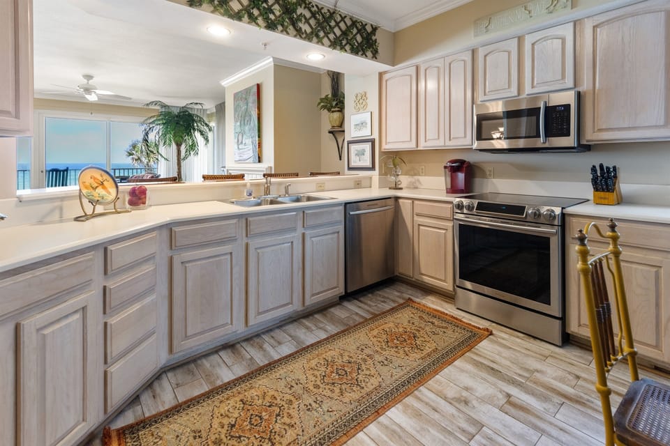 Your fully-equipped kitchen awaits with modern appliances and stunning ocean views - perfect for preparing meals while gazing at the endless blue horizon.