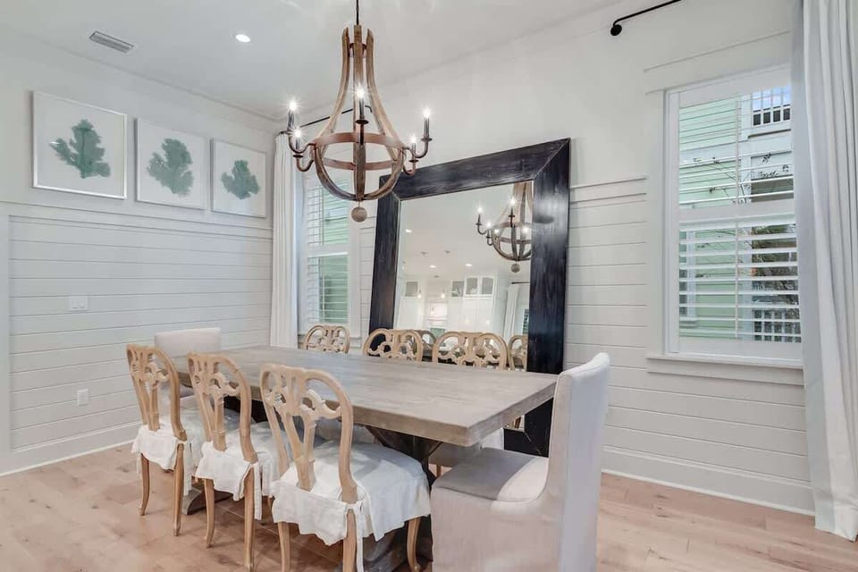- Dining area with a stunning chandelier & a rustic table for eight - Perfect for intimate dinners or larger family meals, this space offers style & comfort - Large mirror & nature inspired art create a relaxing vibe, making every meal a special occa
