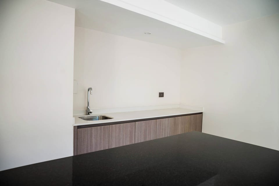 Modern kitchenette with sleek design, perfect for quick meals in your cozy Chilean studio apartment.