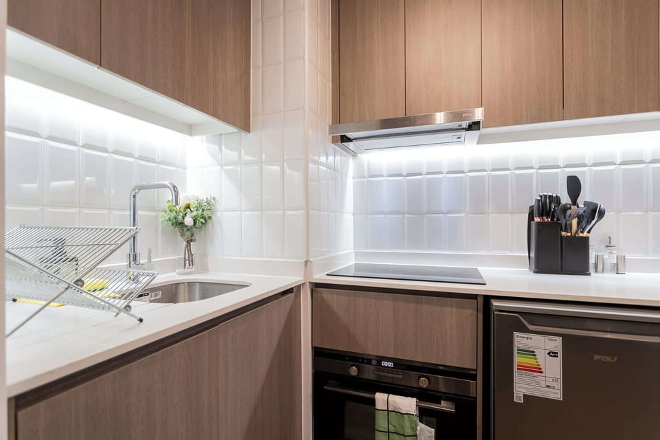 Modern and efficient kitchen with sleek appliances and stylish design, perfect for cozy meals in your Chilean studio retreat.