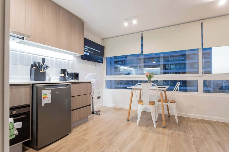 Cozy studio kitchen with city views, perfect for intimate meals and relaxation.