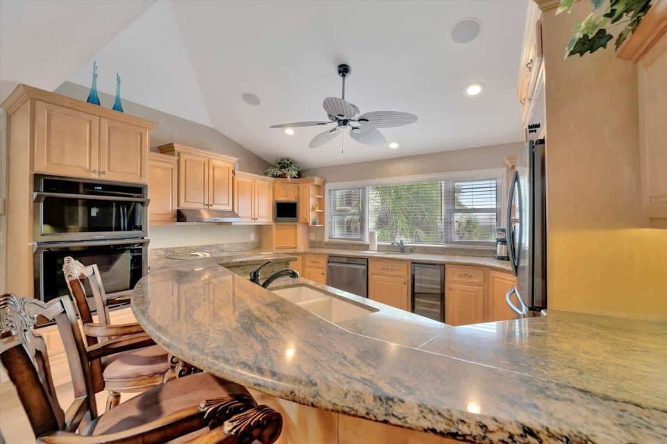 Gather around the breakfast bar in this bright and inviting kitchen