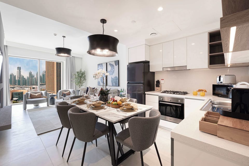 Gather with family and friends around this elegant dining table with six chairs, located next to the living room and fireplace, offering a cozy setting for meals and stunning views of the city skyline.