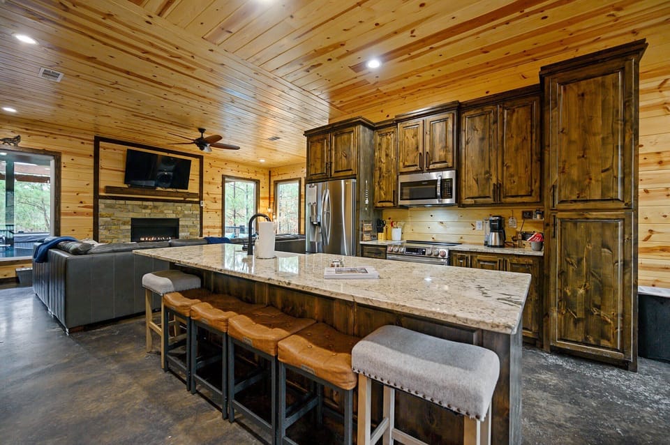 The chic, open kitchen offers ample space & all the comforts of home