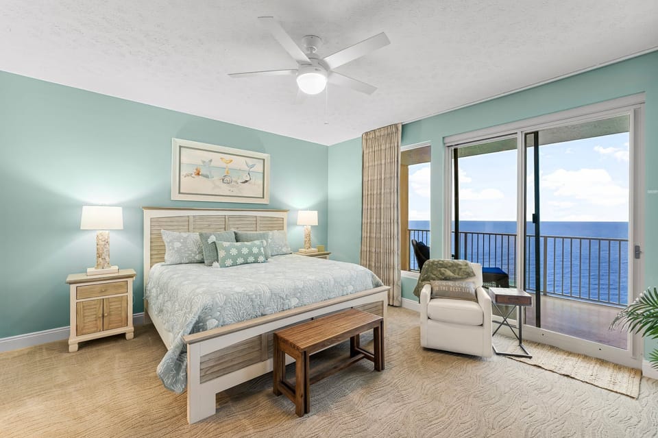 Relax in this coastal bedroom with ocean views and calming blue walls.