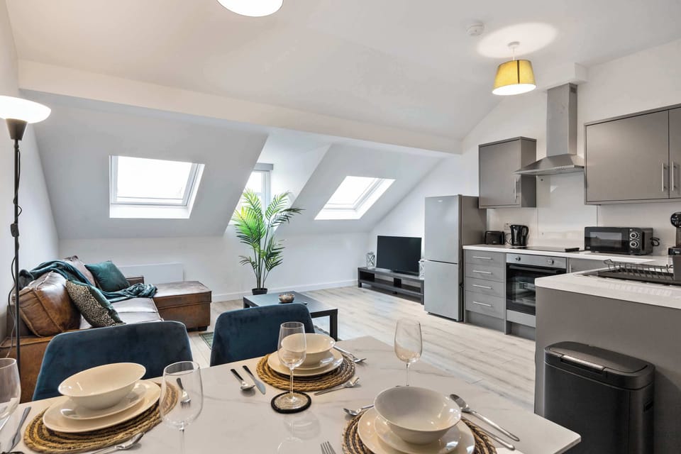 Open plan living, dining and kitchen area with Smart TV