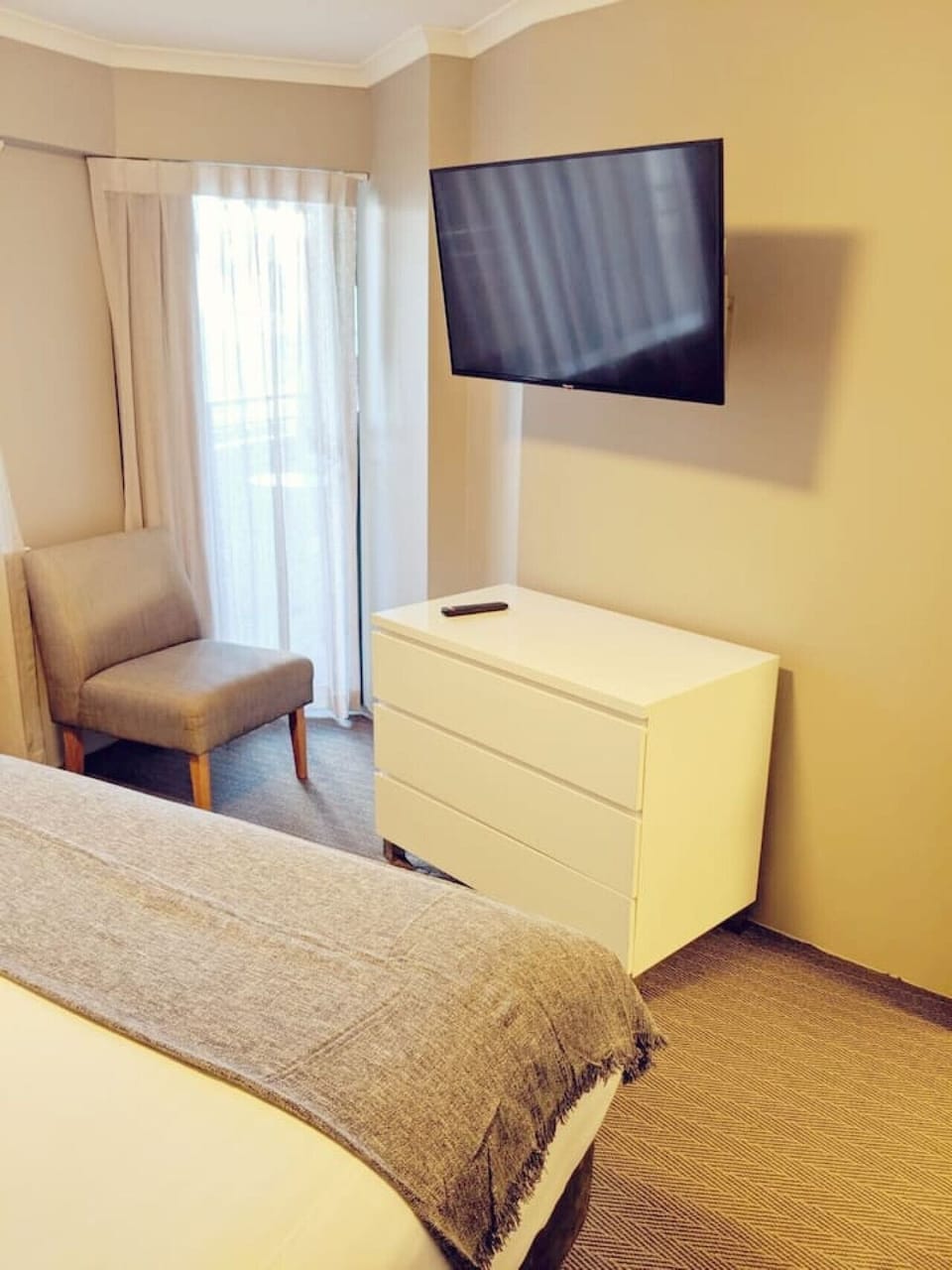Indulge in the luxurious bedroom equipped with an in-room TV, providing endless entertainment options at your fingertips. This elegant space is designed to offer both comfort and convenience, ensuring a restful stay.
