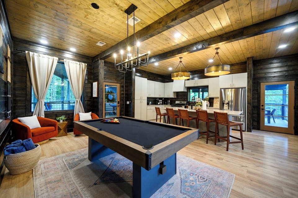 Modern pool table in the main house, just across the kitchen/dining area
