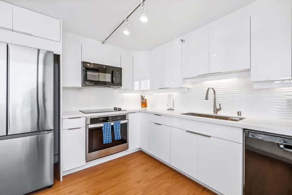 The spacious kitchen features top-of-the-line appliances, ample counter space, and all the essential utensils.