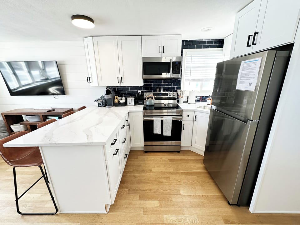 Appliances include a range, microwave and fridge
