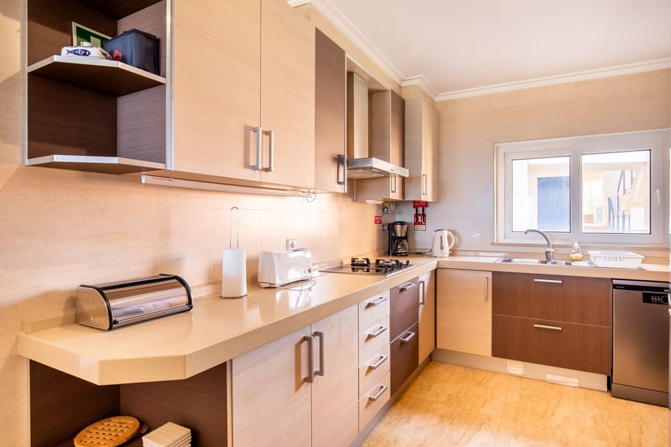 Step into your fully equipped and modern kitchen, designed for your convenience and culinary adventures. You'll find everything you need to prepare delicious meals, including ample counter space, a stove, oven, microwave, and a toaster for your breakfast needs. The well-organized cabinets offer plenty of storage, ensuring a clutter-free environment. This kitchen is ready for you to create memorable dining experiences during your stay.