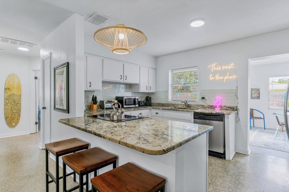 A fully equipped kitchen with granite countertops and a breakfast bar, perfect for cooking and entertaining.